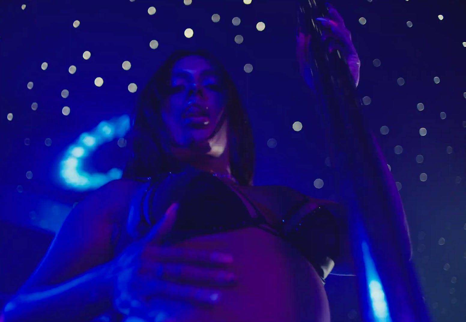 a woman holding a pole in a dark room