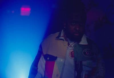 a man standing in front of a blue light