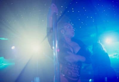 a woman standing in front of a blue light