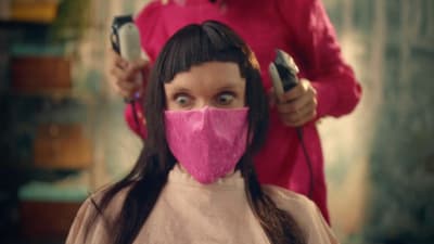 a woman with a pink mask covering her face