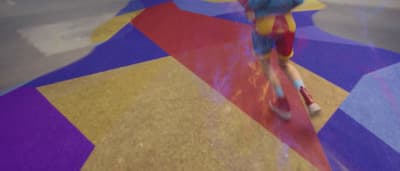 a person riding a skateboard on a colorful floor