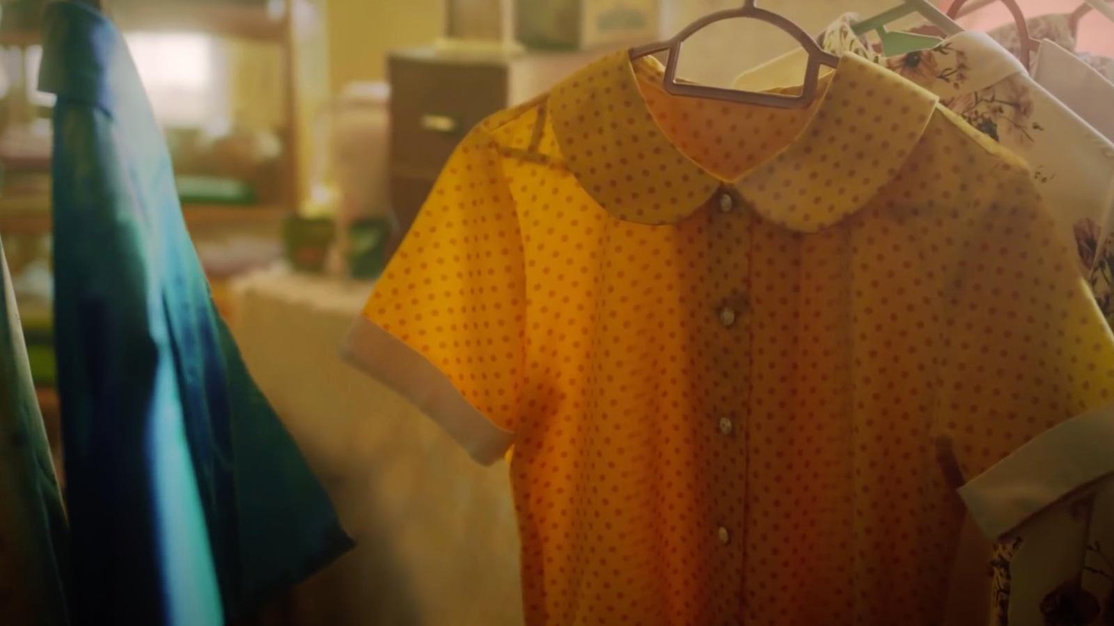 a shirt hanging on a rack in a room