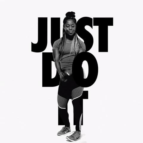 a woman standing in front of a white background with the words just do it