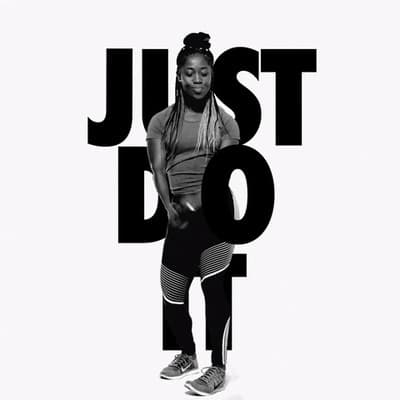 a woman standing in front of a white background with the words just do it