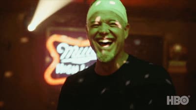 a man with a green mask on smiling