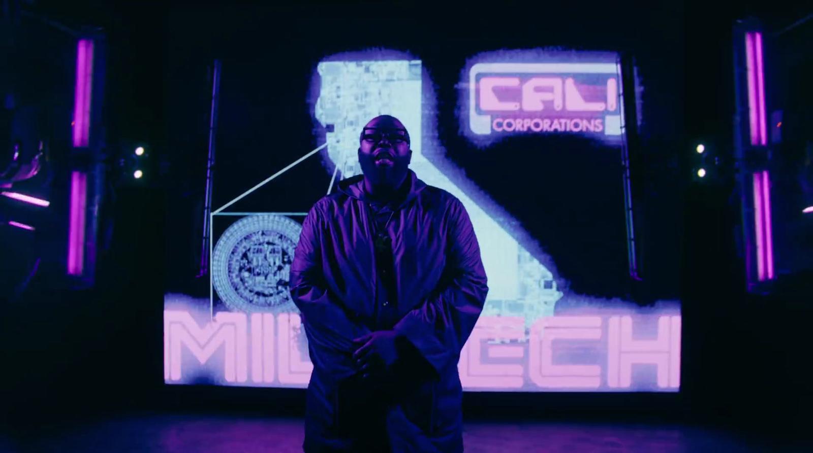 a man standing in front of a large screen