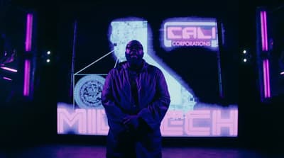 a man standing in front of a large screen