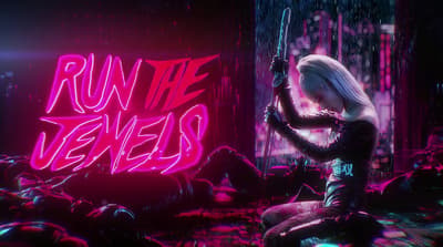 a woman sitting on the ground in front of a neon sign