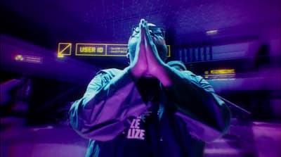 a man standing in front of a purple light