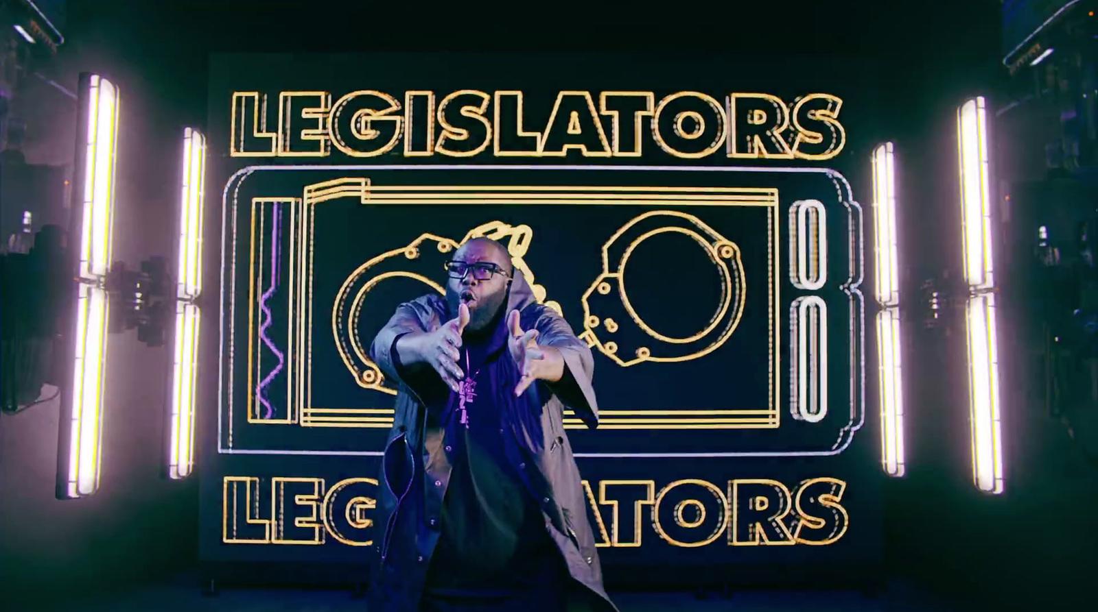 a man standing in front of a neon sign