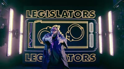 a man standing in front of a neon sign