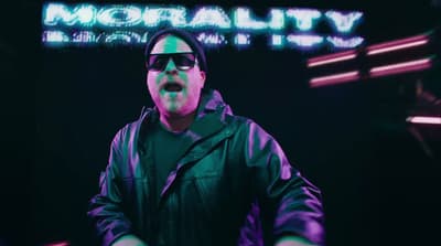 a man in a black jacket and sunglasses