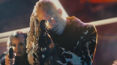 a man holding a gun in his right hand