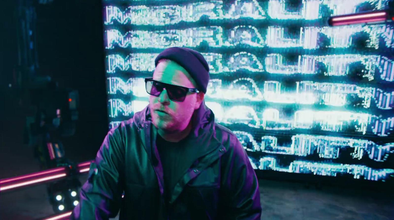 a man wearing sunglasses and a black hat