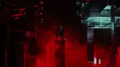 a person standing on a ledge in a dark room
