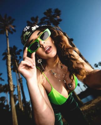 a woman wearing sunglasses and a bandana