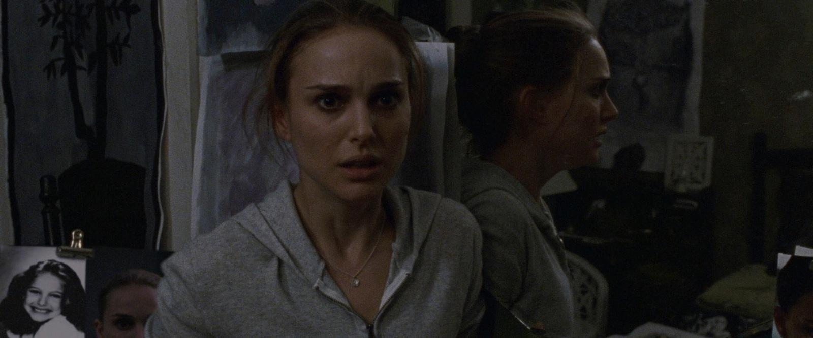 a woman standing next to another woman in a room