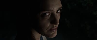 a close up of a person in a dark room