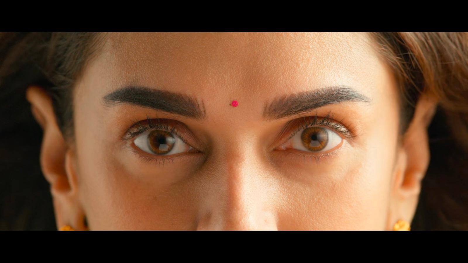 a close up of a woman's face with brown eyes
