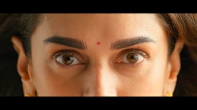 a close up of a woman's face with brown eyes