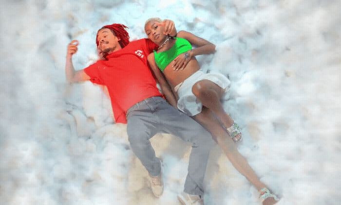 a man and a woman are laying on the snow