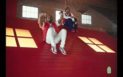 a group of people sitting on top of a red roof