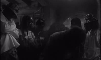 a group of people standing around each other