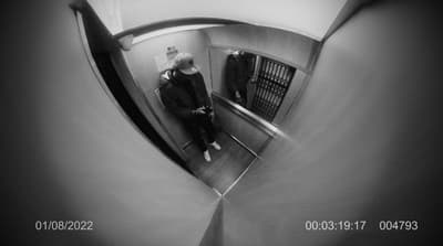 a man riding an escalator down a hallway