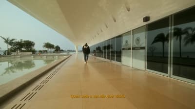 a person walking down a walkway next to a building