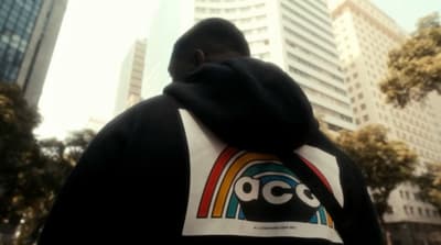 a man in a black hoodie with a dc logo on it