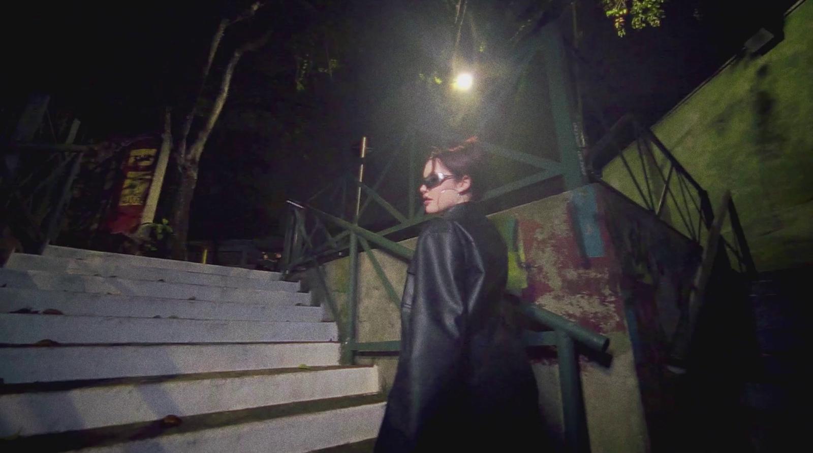 a person standing on some steps at night