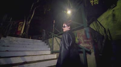 a person standing on some steps at night
