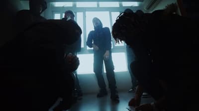 a group of people standing in front of a window
