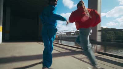 a couple of people that are standing on a bridge