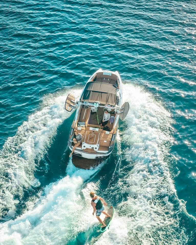 a couple of people riding on the back of a boat