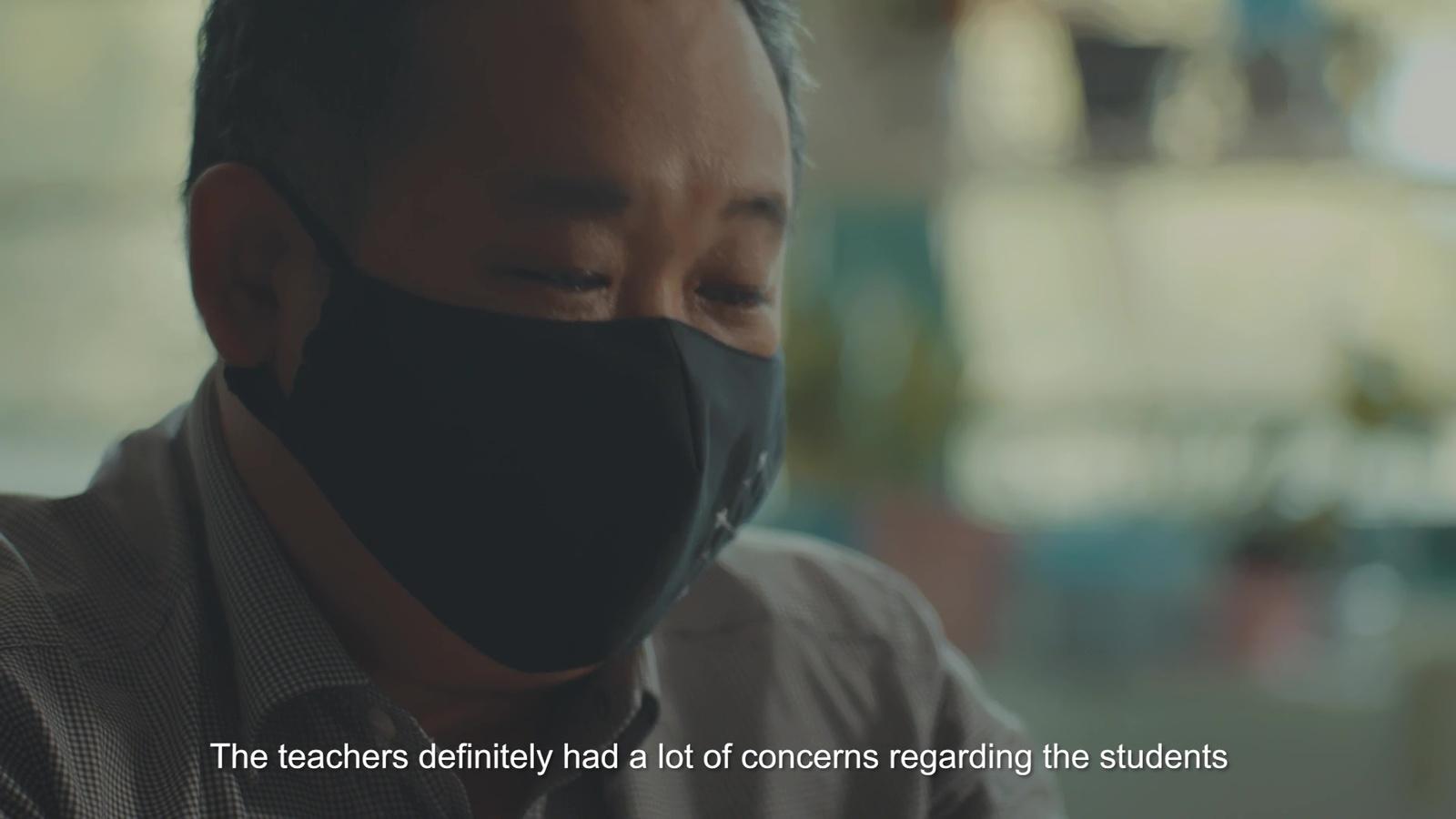 a man wearing a black face mask with a quote on it