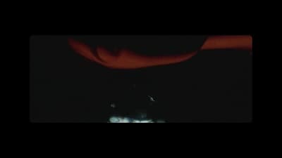 a blurry photo of a person's face in the dark