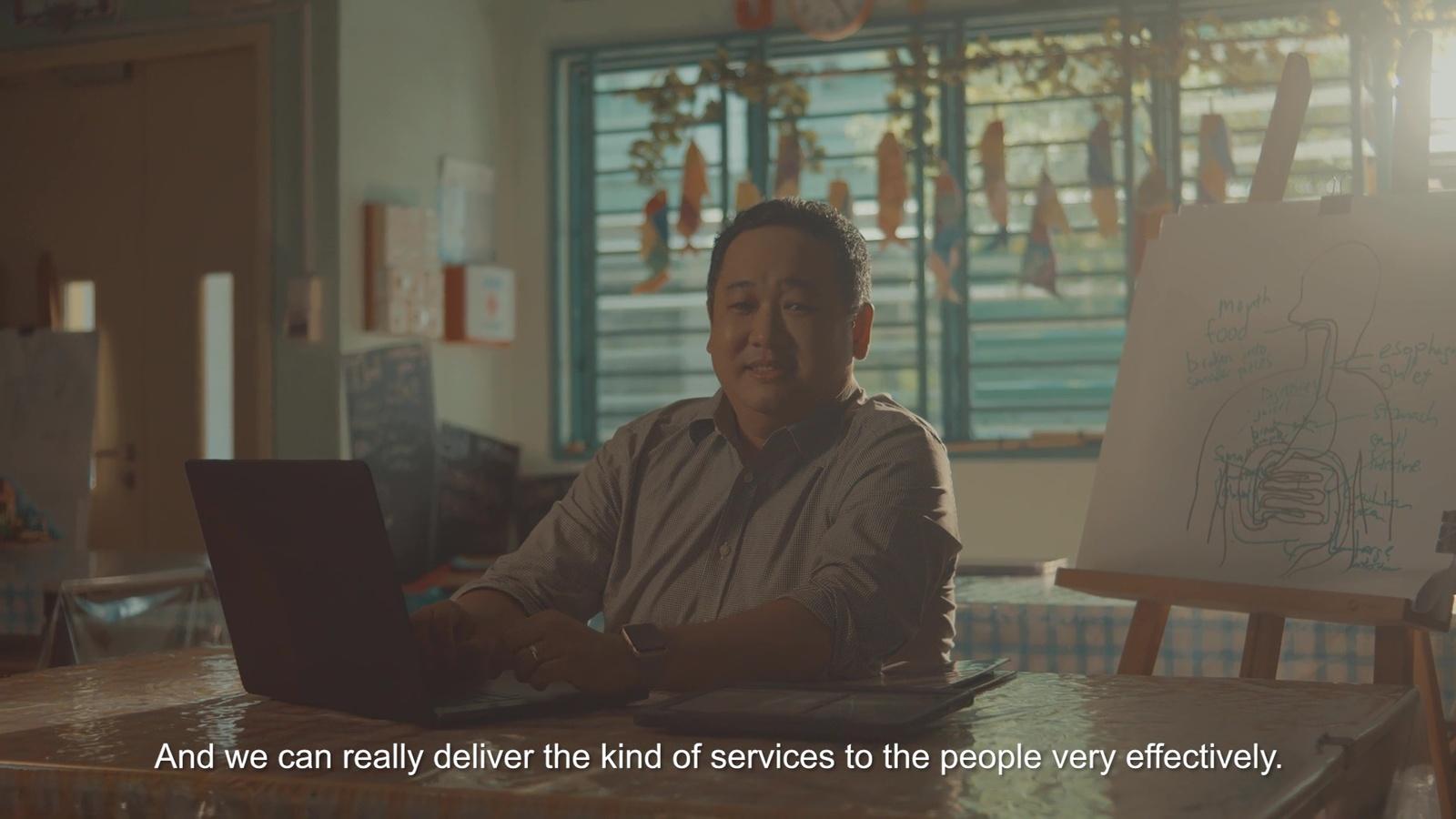 a man sitting in front of a laptop computer