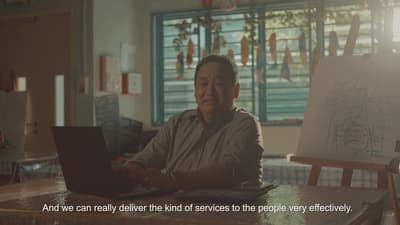 a man sitting in front of a laptop computer