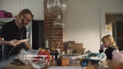 a man standing next to a little girl in a kitchen