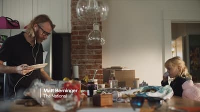 a man standing next to a little girl in a kitchen
