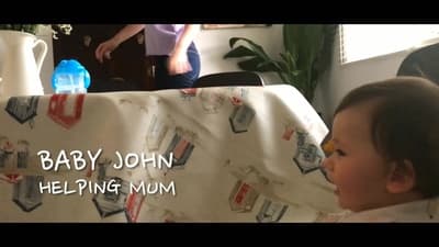 a baby sitting in a highchair next to a table