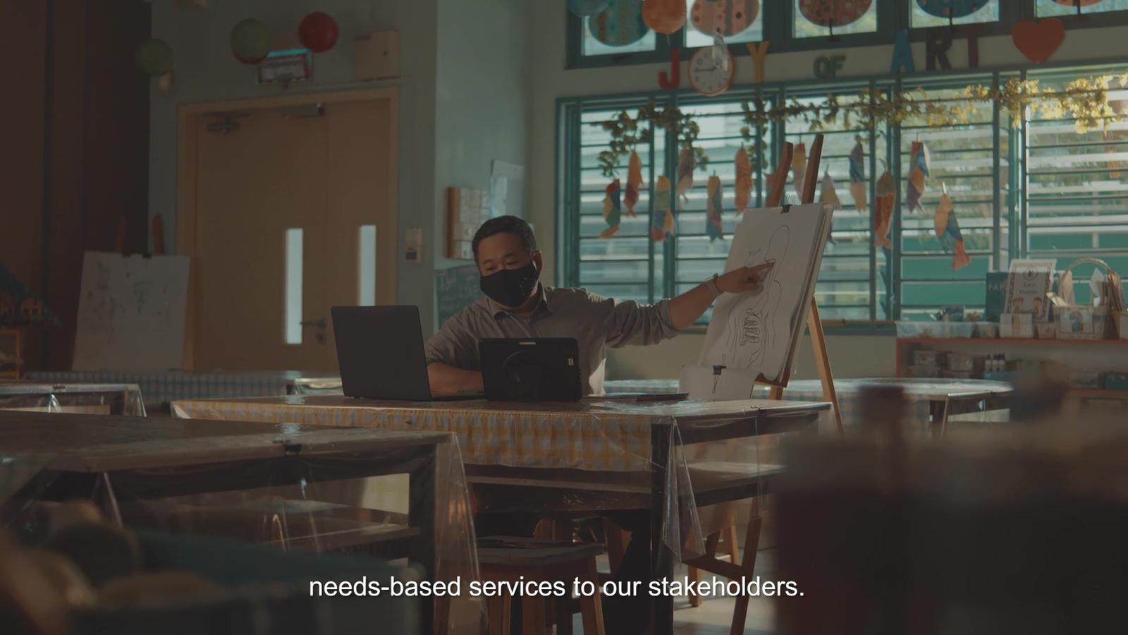 a man sitting in front of a laptop computer