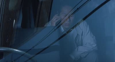 a man sitting in a bus talking on a cell phone