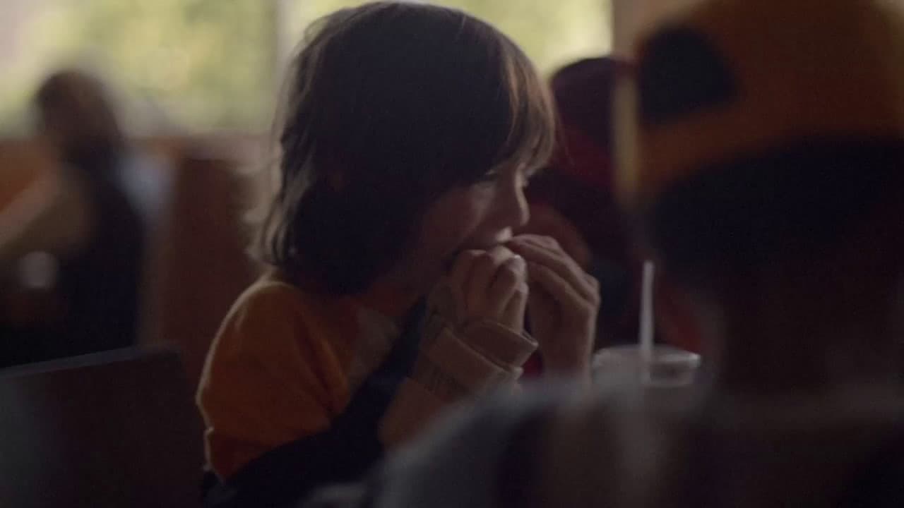 a woman sitting at a table in a restaurant