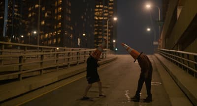 a couple of people that are standing on a bridge