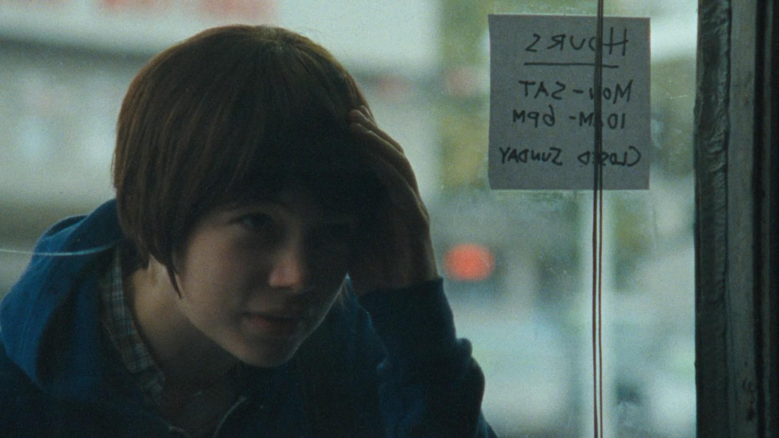 a person with a sign on a window