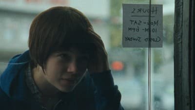 a person with a sign on a window