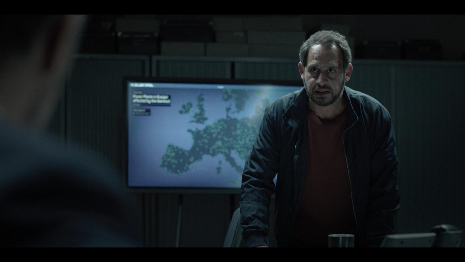 a man standing in front of a tv screen