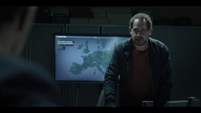 a man standing in front of a tv screen